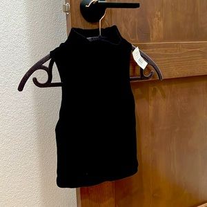New with tags Black sleeveless turtle neck crop top. Size Small.